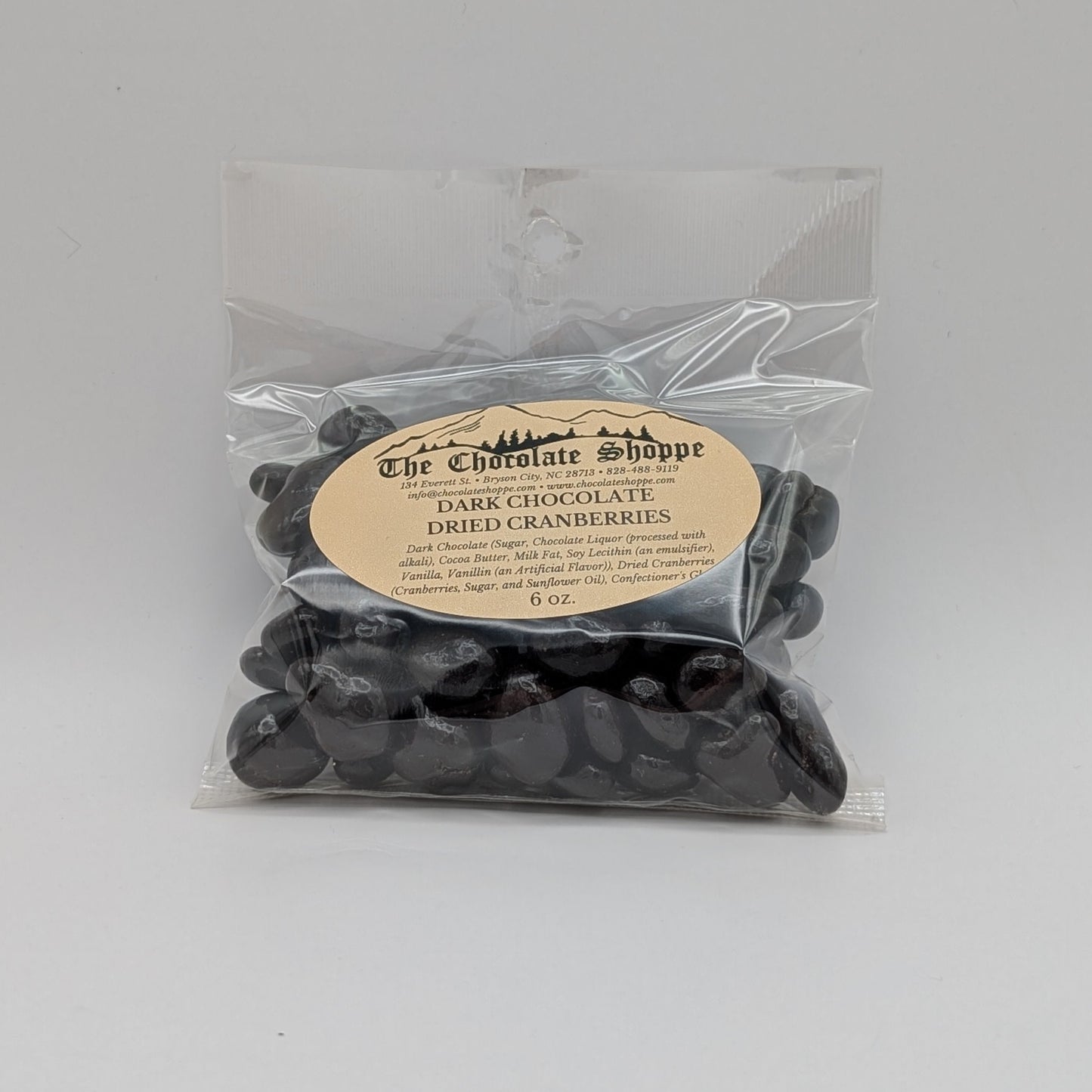 Packaged dark cranberries with a label on a white background