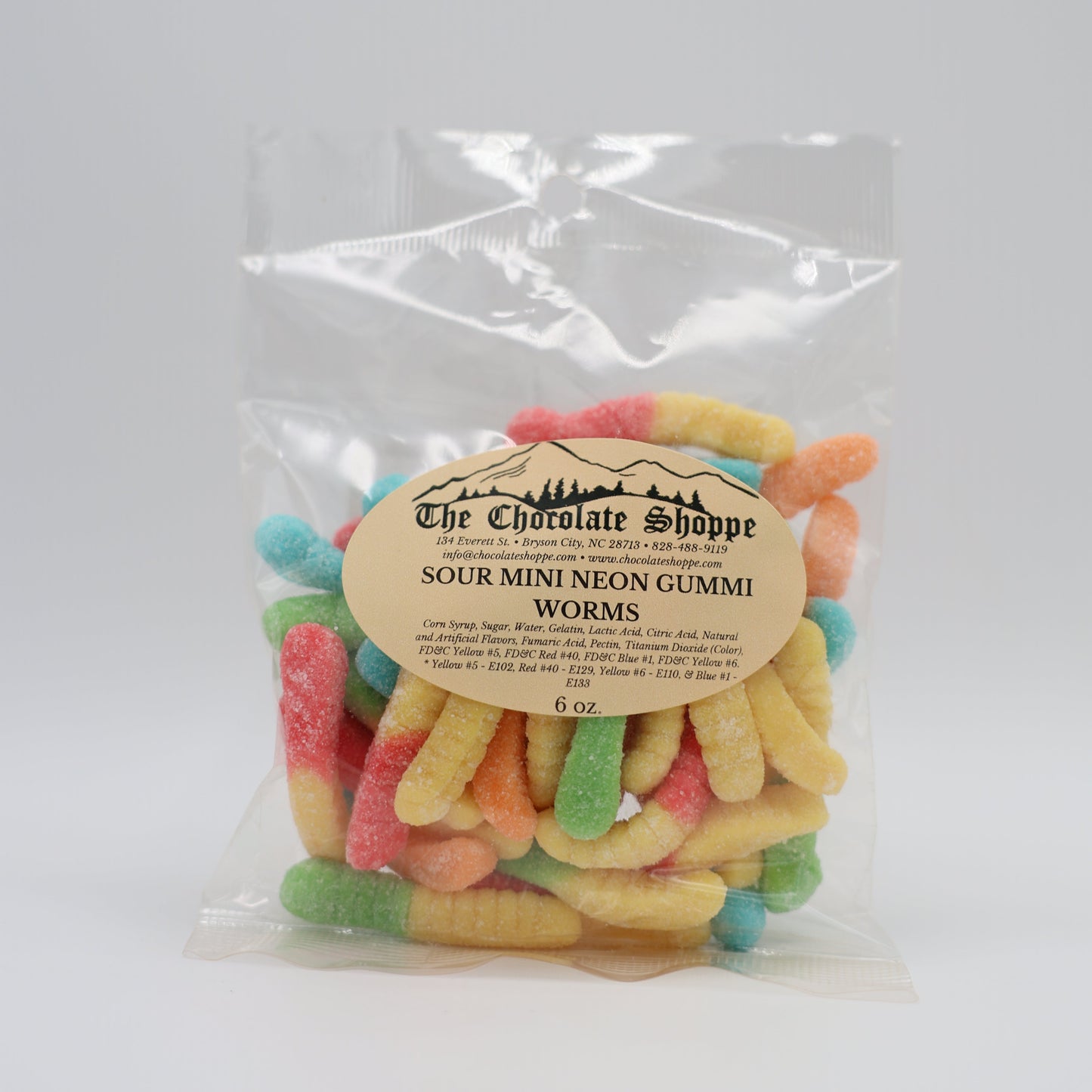 Packaged sour gummy worms with a visible brand label on a white background