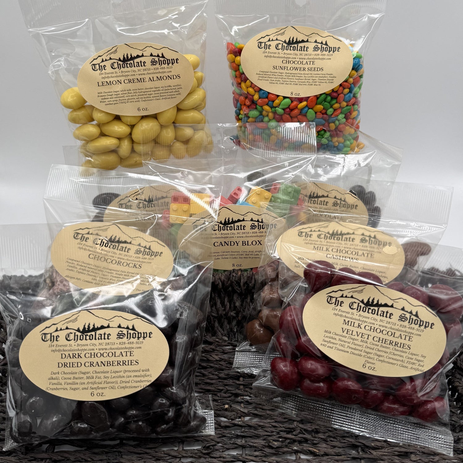 A collection of chocolate covered items such as raisins, nuts, cherries, caramel, and more
