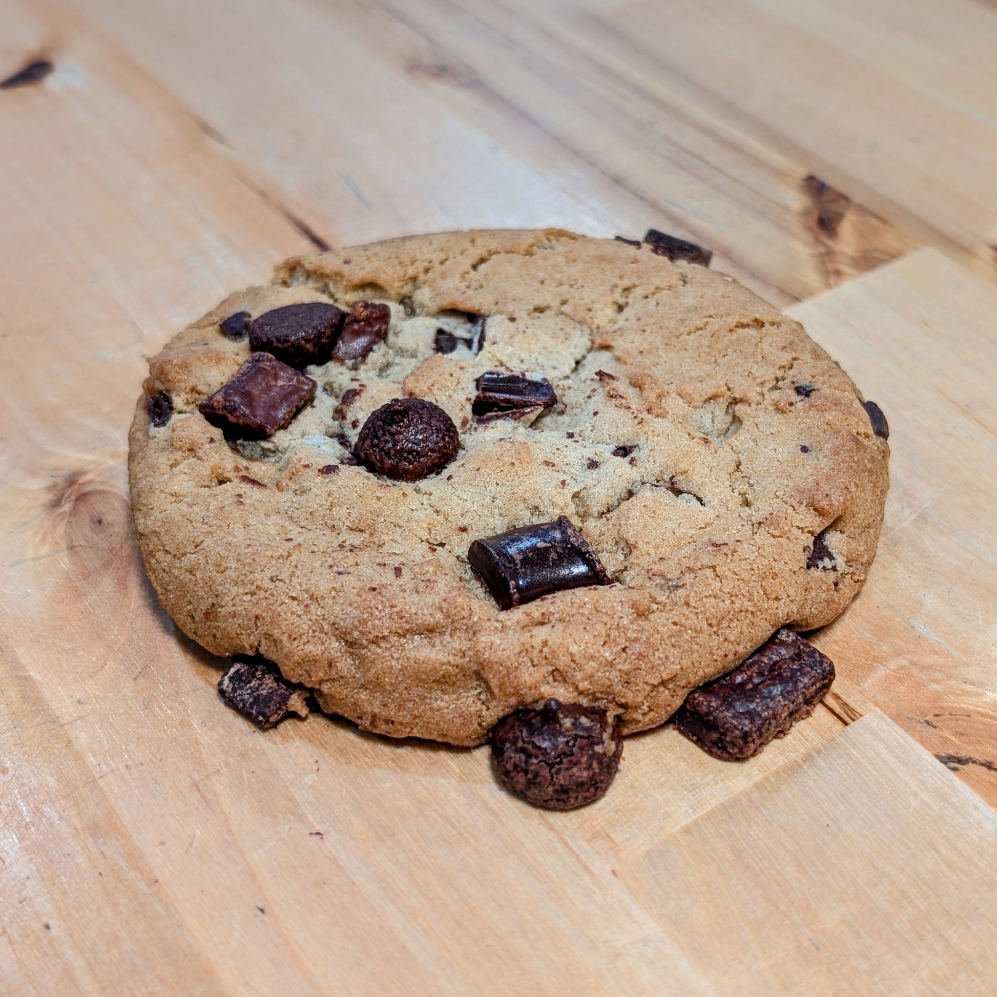 Chocolate chip cookie on a wooden surface
