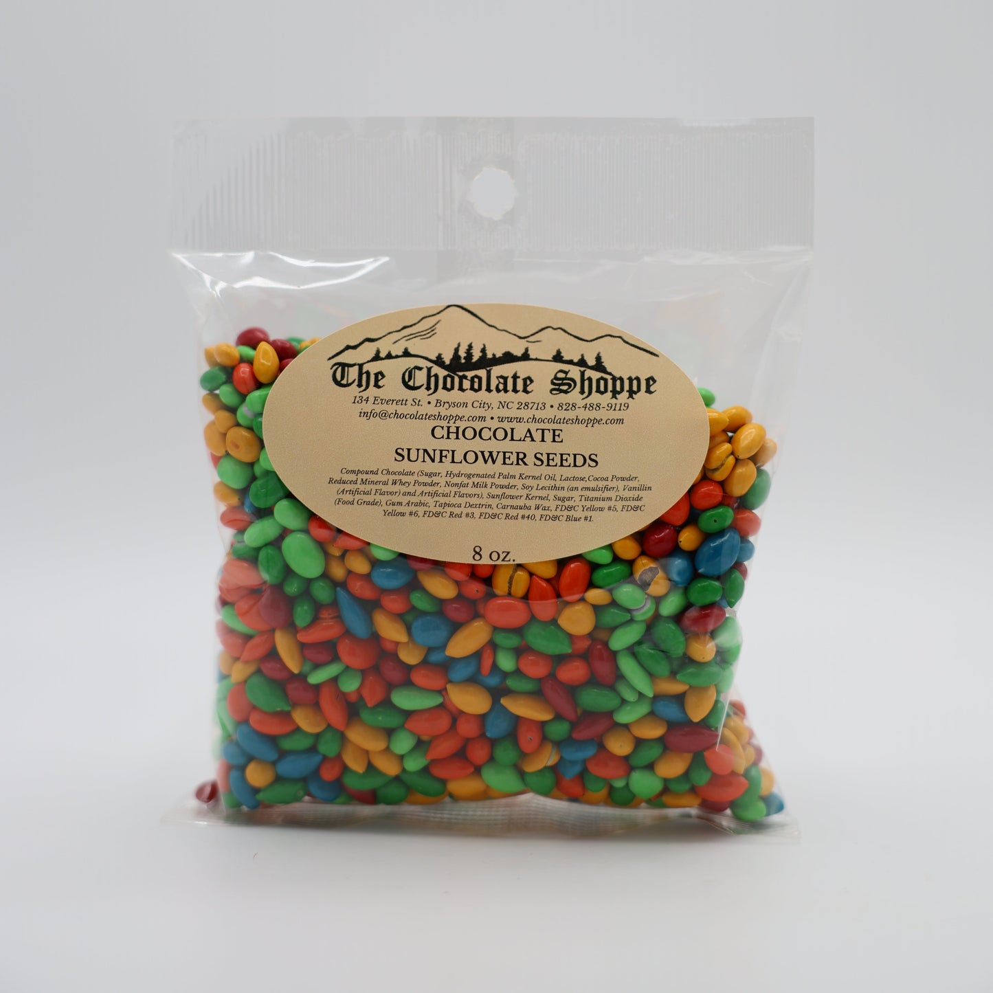 Bag of colorful chocolate covered sunflower seeds with a label on a white background
