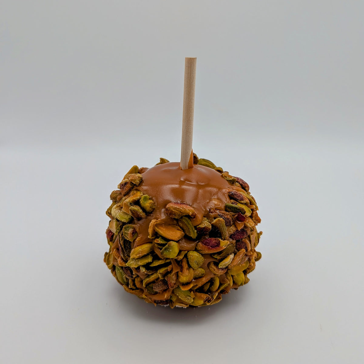 Caramel Apple rolled in roasted pistachios